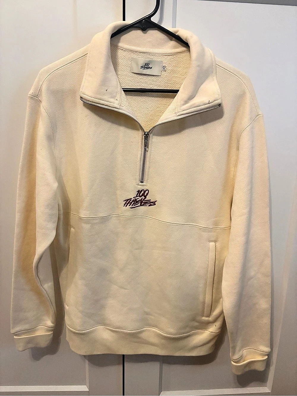 100 Thieves cream quarter-zip sweatshirt